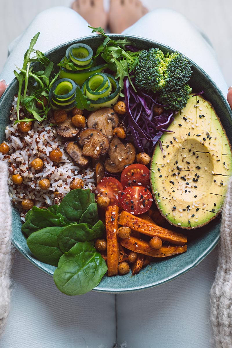 Healthy eating. Plate with vegan or vegetarian food in woman hands. Healthy plant based diet. Healthy dinner. Buddha bowl with fresh vegetables